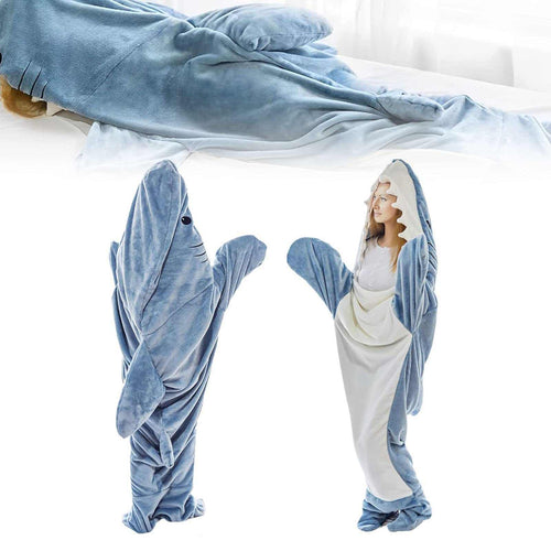 Person wearing cozy wearable shark sleeping blanket indoors