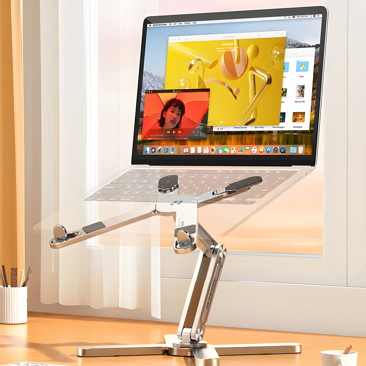 Rotating adjustable laptop stand in silver with folding frame and silicone grips for flexible desk setups