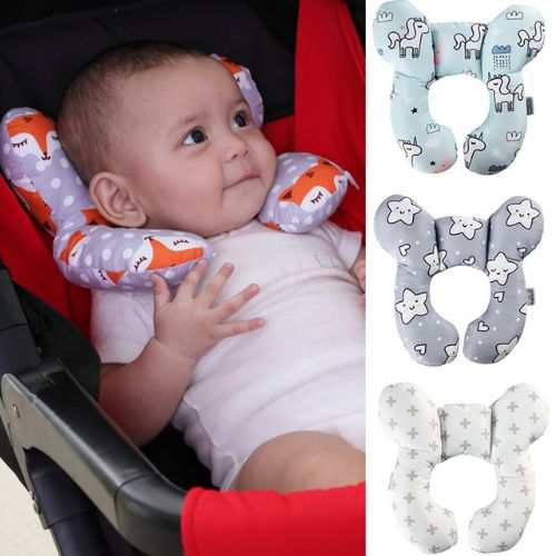 Baby sleeping comfortably with neck supported by soft baby travel pillow in car seat