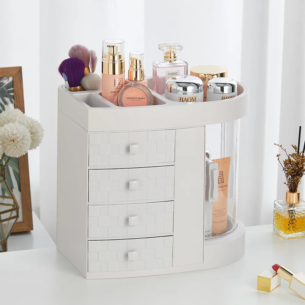 White rotating makeup organizer with clear drawers and compartments for cosmetics and brushes on a vanity table