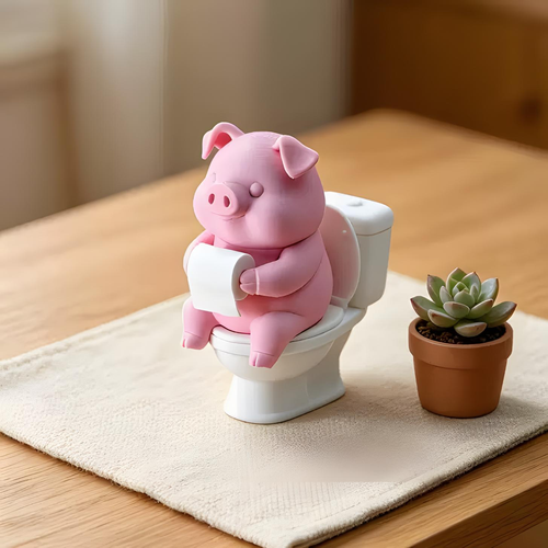 Pink pig toilet paper holder ornament sitting on miniature toilet for bathroom decor