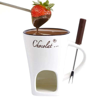 White ceramic fondue mug melting chocolate with candle underneath on wooden table